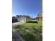 View of garage with driveway and grass with back of house in the distance at 1641 English Ave, Indianapolis, IN 46201