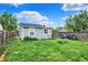 Backyard offers greenery, a wood fence, and space for recreation; potential for outdoor enjoyment and gardening at 1641 Iowa St, Indianapolis, IN 46203