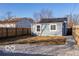 View of the home's exterior and the backyard with a gravel area, offering a private outdoor space at 1641 Iowa St, Indianapolis, IN 46203