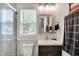 Bathroom features a sleek vanity, framed mirror, modern fixtures, and a glass-enclosed shower for a spa-like experience at 1641 Iowa St, Indianapolis, IN 46203