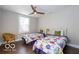 This bedroom features twin beds, dark wood floors, and a window overlooking the yard at 1641 Iowa St, Indianapolis, IN 46203