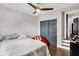 Bedroom featuring dark closet doors, wood floors, and natural light from window at 1641 Iowa St, Indianapolis, IN 46203