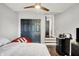Bedroom featuring dark closet doors, wood floors, and natural light from window at 1641 Iowa St, Indianapolis, IN 46203