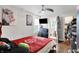 Bright bedroom features a ceiling fan, TV, and en suite bathroom with modern finishes and decor at 1641 Iowa St, Indianapolis, IN 46203