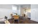 Bright dining area adjacent to the kitchen with wainscoting and modern table with four chairs at 1641 Iowa St, Indianapolis, IN 46203