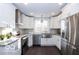 Modern kitchen featuring stainless steel appliances, granite countertops, and white cabinetry at 1641 Iowa St, Indianapolis, IN 46203