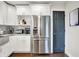 Kitchen featuring stainless steel refrigerator and white cabinets, with backsplash at 1641 Iowa St, Indianapolis, IN 46203