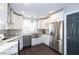 Modern kitchen with stainless steel appliances, granite countertops, and sleek white cabinets at 1641 Iowa St, Indianapolis, IN 46203