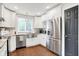 Modern kitchen featuring stainless steel appliances, white cabinetry, and granite countertops at 1641 Iowa St, Indianapolis, IN 46203
