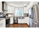 Bright kitchen with stainless steel appliances, white cabinetry, granite countertops, and modern lighting at 1641 Iowa St, Indianapolis, IN 46203