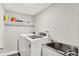 Functional laundry room with modern washer, dryer, and sink at 1641 Iowa St, Indianapolis, IN 46203