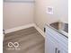 Laundry room with vinyl floors and a stainless steel sink at 1641 Iowa St, Indianapolis, IN 46203