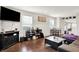 Open living area with a flat screen television, wood floors, and natural light at 1641 Iowa St, Indianapolis, IN 46203