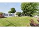 Spacious backyard featuring lush lawn, mature trees, and fenced-in area with additional garage at 1855 Cruft St, Indianapolis, IN 46203