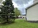 Landscaped backyard featuring mature trees and a patio with outdoor furniture at 18680 Long Walk Ln, Noblesville, IN 46060