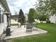 Stone patio with outdoor seating, including a pergola and chairs, perfect for outdoor relaxation at 18680 Long Walk Ln, Noblesville, IN 46060