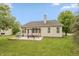 Backyard featuring a pergola-covered patio, lush green lawn, and mature trees, creating a perfect outdoor retreat at 18680 Long Walk Ln, Noblesville, IN 46060