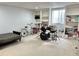 Wide open basement area featuring a sofa, bike, drum set, and built-in shelves at 18680 Long Walk Ln, Noblesville, IN 46060