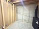 Unfinished basement with exposed framing and concrete wall, offering opportunity for personalization at 18680 Long Walk Ln, Noblesville, IN 46060