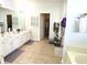 Bathroom featuring double vanity sinks, tile floor, and linen closet at 18680 Long Walk Ln, Noblesville, IN 46060