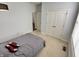 A cozy bedroom featuring a double door closet and carpeted floors at 18680 Long Walk Ln, Noblesville, IN 46060