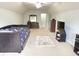 Spacious room with a bed, dresser, TV, and large carpet, well lit by natural light at 18680 Long Walk Ln, Noblesville, IN 46060