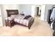 Bedroom featuring a wood bed frame, side table, and plush carpet at 18680 Long Walk Ln, Noblesville, IN 46060