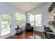 Bright breakfast nook area with large windows and a door to the patio, adjacent to the kitchen at 18680 Long Walk Ln, Noblesville, IN 46060
