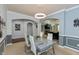 Formal dining room with modern lighting and open floor plan to living room at 18680 Long Walk Ln, Noblesville, IN 46060
