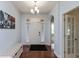 Welcoming entryway boasts hardwood floors, a stylish light fixture, and convenient bench seating at 18680 Long Walk Ln, Noblesville, IN 46060
