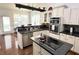 Well-lit kitchen with stainless steel appliances, white cabinets, and a breakfast bar area at 18680 Long Walk Ln, Noblesville, IN 46060