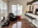 Inviting living area with hardwood floors, natural light, and an adjacent breakfast bar at 18680 Long Walk Ln, Noblesville, IN 46060