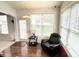 Sunlit living room with hardwood floors, large windows, and a comfortable recliner at 18680 Long Walk Ln, Noblesville, IN 46060