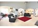 Open living space with black leather recliners and access to the kitchen and dining area at 18680 Long Walk Ln, Noblesville, IN 46060