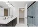 Modern bathroom with double vanity, stylish mirrors, and a glass-enclosed shower at 1906 N Park Ave, Indianapolis, IN 46202