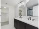 Bathroom featuring double sinks, modern fixtures, and access to the shower and walk-in closet at 1906 N Park Ave, Indianapolis, IN 46202