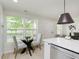 Bright dining area featuring a glass table, comfortable chairs, and a view of the outdoors at 1906 N Park Ave, Indianapolis, IN 46202