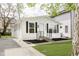 Quaint white home featuring a lush lawn and a freshly painted exterior at 1906 N Park Ave, Indianapolis, IN 46202