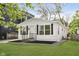 Side view of a renovated white home with new landscaping and refreshed features at 1906 N Park Ave, Indianapolis, IN 46202