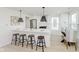 Modern kitchen featuring a breakfast bar with seating, stainless steel appliances, and sleek countertops at 1906 N Park Ave, Indianapolis, IN 46202