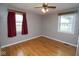 This bedroom has two windows, ceiling fan, and wood floors at 1970 E 1100 N, Alexandria, IN 46001