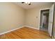 Cozy bedroom featuring hardwood floors, neutral walls, and open doorway to bathroom at 1970 E 1100 N, Alexandria, IN 46001