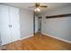 This bedroom features a ceiling fan, wood floors, and barn door closet at 1970 E 1100 N, Alexandria, IN 46001