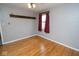 This bedroom features wood floors, a ceiling fan, and a wall shelf at 1970 E 1100 N, Alexandria, IN 46001