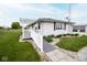 Charming one-story home with a landscaped front yard, accessibility ramp, and a detached garage at 1970 E 1100 N, Alexandria, IN 46001