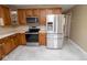 View of the kitchen showcasing stainless steel appliances and wood cabinets at 1970 E 1100 N, Alexandria, IN 46001