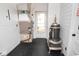 Mud room including an antique stove and modern furnace with herringbone pattern tile floors at 1970 E 1100 N, Alexandria, IN 46001