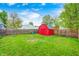 A large grass backyard featuring a storage shed at 2021 Reformers Ave, Indianapolis, IN 46203