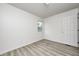 Empty bedroom with updated flooring, base trim, and a window for natural light at 2021 Reformers Ave, Indianapolis, IN 46203