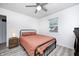 This bedroom features a ceiling fan, updated flooring, and a window for natural light at 2021 Reformers Ave, Indianapolis, IN 46203